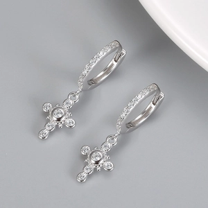 Close-up of S925 silver hoop earrings with luxurious cross pendants and white zircon stones