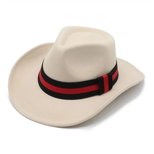 Detail shot of beige cowboy hat felt texture and decorative red and black braided band
