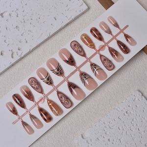 Caramel zebra print almond press-on nails with 3D floral accents and amber design