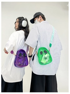 Detailed view of clear PVC crossbody jelly bags in purple and green with round accents