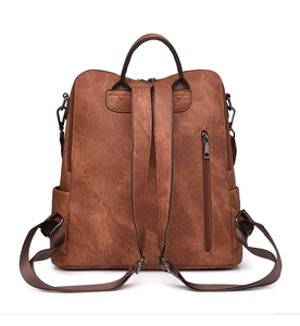 Back view of brown PU leather backpack showing adjustable straps and zipper pocket