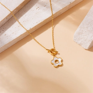 Elegant gold chain necklace with shell flower pendant and OT toggle clasp on stones