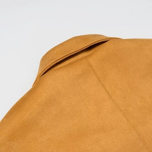 Close-up of the collar and suede fabric texture on a brown British style poncho coat