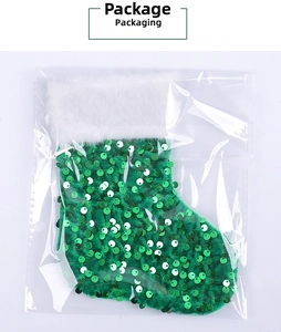 Close-up of green sequin Christmas stocking with white faux fur trim in clear packaging