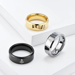 Detailed macro view showing the gold, silver and black masonic rings on white podiums