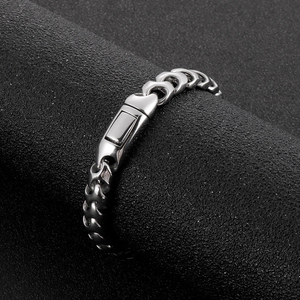 Detail of silver stainless steel Cuban link bracelet with industrial press buckle clasp