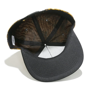 Detail of flat brim cap showing 100% cotton label and leopard print inner lining