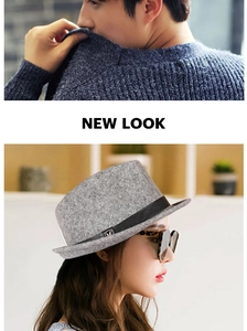 Close-up of a grey wool felt fedora hat featuring a black band and metallic letter detail