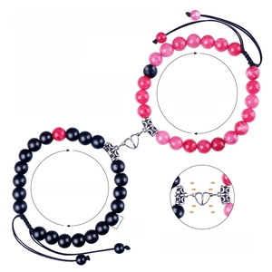 Detail showing 8mm natural stone magnetic couple bracelets with adjustable size info