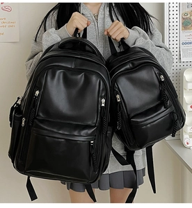 Detailed comparison of large and small black faux leather backpacks with zipper pulls