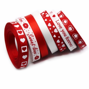 Close-up of red and white 9mm ribbons with Sweet Love prints for gift wrapping
