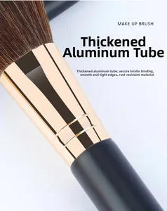 Close-up of thick gold aluminum ferrule and soft bristles on a mini makeup brush
