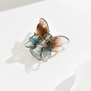 Detailed top view of 3.5cm gradient brown and blue butterfly hair clip on white background
