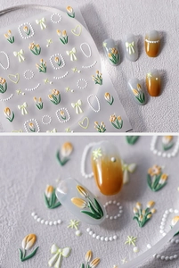 Makro-Detail von 5D-geprägten Nagelstickern mit gelben Tulpen und Perlenmotiven