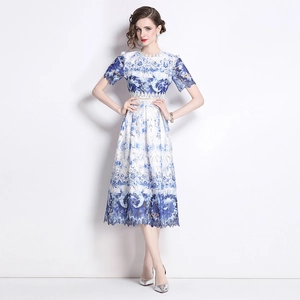 Elegant white lace midi dress with blue porcelain print and eyelash lace hem detail
