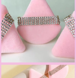 Macro detail of silver rhinestone choker necklace with sparkling crystals and metal base