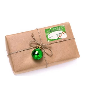 Christmas polar bear gift labels with snowflakes on a kraft paper wrapped box with green ball