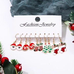 Detailed view of five pairs of Christmas earrings including Santa and festive trees