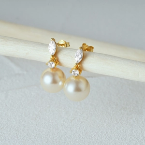 Detail of S925 silver pearl earrings with marquise zircon and engraved hallmark