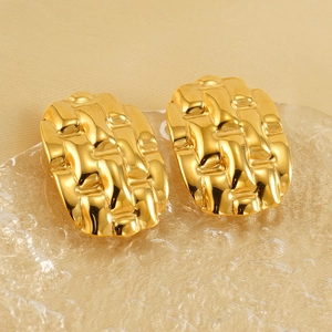 Detailed macro view of 18k gold plated stainless steel earrings with woven texture