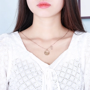 Rose gold hollow horse pendant necklace with sparkling crystals on white lace blouse