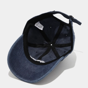 Inside view of navy blue washed cotton baseball cap with sweatband and metal buckle