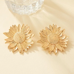 Detailed view of gold sunflower stud earrings featuring intricate metallic petal textures