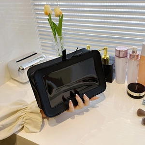 Black faux leather floral toiletry bag featuring a clear window and durable handle