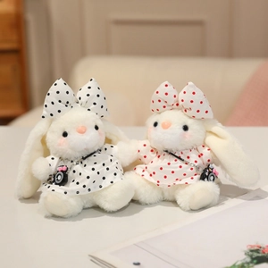 Plush white bunny charms in polka dot dresses with mini camera accessories for bags