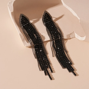 Detailed view of dark style tassel earrings with black rhinestones and triangle studs
