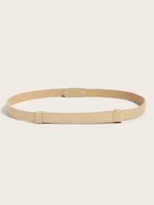 Detail shot of apricot slim belt with cross-grain texture on a beige background