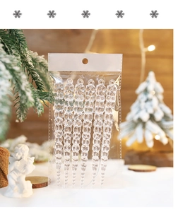 Clear spiral icicle ornaments hanging on a Christmas tree with festive warm light