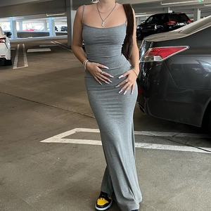 Street style shot of a grey slim fit sleeveless maxi dress with a sleek high-waist design