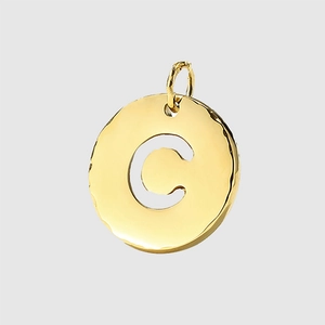 Golden round pendant with hollow letter C and hammered texture on white background