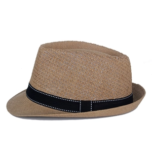 Detail of breathable hollow weave and black ribbon on a summer straw fedora sun hat