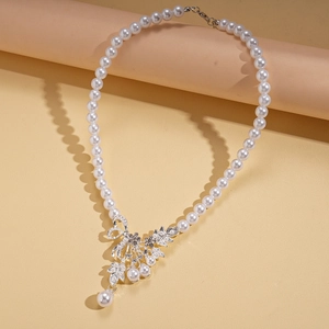 Detail of silver floral pendant with zircon leaves and pearl on elegant sweater necklace