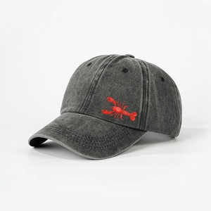 Close-up of red lobster embroidery on washed charcoal grey cotton baseball cap texture
