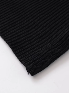 Close-up of black ribbed knit fabric showing detailed texture and stitching quality