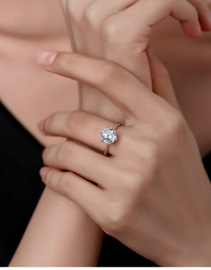 Macro shot of 925 sterling silver ring featuring a six-prong set 2-carat moissanite stone