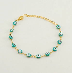 Detail of adjustable lobster clasp and extension chain on golden evil eye bracelet