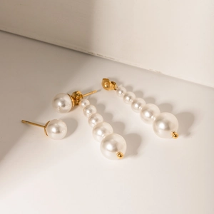 18k gold-plated stainless steel earrings featuring cascading white pearls in a minimalist design