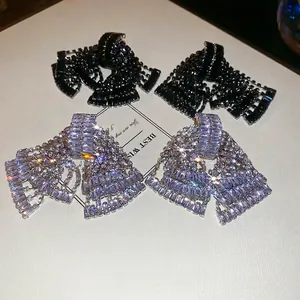 Luxury geometric bow earrings set with sparkling rhinestones and silver tassels