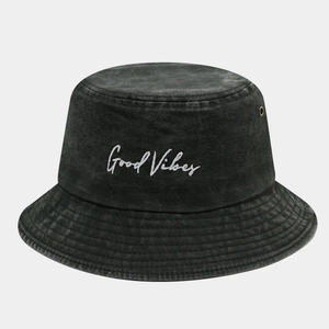 Detail of Good Vibes embroidery and brass eyelets on black washed denim bucket hat