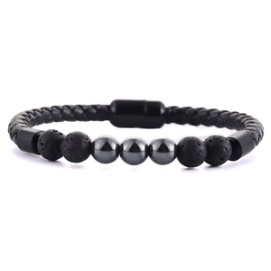Detail of men's braided leather bracelet with lava stone beads and magnetic clasp