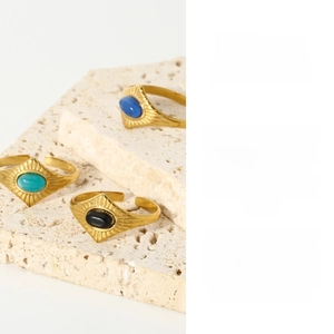 Detail of vintage 18k gold plated stainless steel rings with natural stone inlays