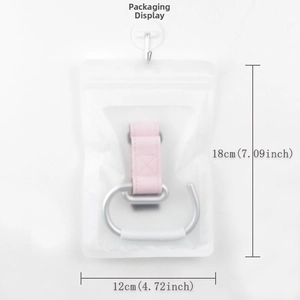 Detail view of universal stroller hook with pink leather strap in zip-lock packaging