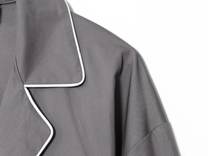 Detailed macro view of the grey poplin shirt collar with white trim and twill texture