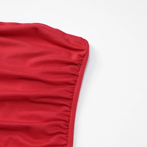 Detail of red knit dress neckline with elegant ruching and precise stitching edges