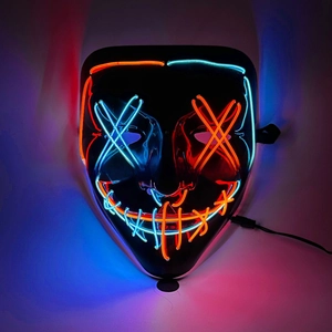 Close-up of glowing blue and orange EL wires on a black LED mask for themed parties