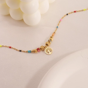 Golden stainless steel beaded bracelet featuring a tree of life pendant in boho style